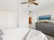 A clean bedroom with carpet, a TV, and a grey dresser for ample storage space at 2155 Wood St # B18, Sarasota, FL 34237