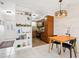 View of Dining area leading to kitchen, wood table and two black chairs at 2155 Wood St # B18, Sarasota, FL 34237