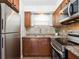 A cozy kitchen with wood cabinets, stainless steel appliances, and stone-look countertops at 2155 Wood St # B18, Sarasota, FL 34237