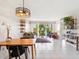 Bright living room featuring modern decor, tile floors, and sliding doors to a balcony at 2155 Wood St # B18, Sarasota, FL 34237