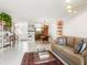 Open concept living room showcasing tile flooring, a tan sofa, and an adjacent dining area at 2155 Wood St # B18, Sarasota, FL 34237