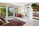 Stylish living space featuring a glass coffee table, sliding glass door to a balcony, and neutral decor at 2155 Wood St # B18, Sarasota, FL 34237