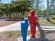 A park sculpture features red and blue figures against a backdrop of trees and green spaces at 2155 Wood St # B18, Sarasota, FL 34237