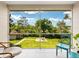 Enclosed screened lanai with tile flooring and green outdoor views at 2155 Wood St # B18, Sarasota, FL 34237
