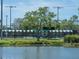 The park tennis courts are next to a serene pond and shaded by a mature tree at 2155 Wood St # B18, Sarasota, FL 34237