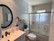 Well-lit bathroom with modern black fixtures and a sliding glass shower door at 240 Patterson Ave, Osprey, FL 34229