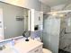 Clean bathroom featuring a vanity, cabinet, toilet, and updated tile shower at 240 Patterson Ave, Osprey, FL 34229