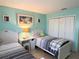 Bright bedroom features twin beds, a closet, and lots of space at 240 Patterson Ave, Osprey, FL 34229