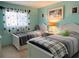 Charming bedroom has twin beds, and a shared nightstand and neutral colors at 240 Patterson Ave, Osprey, FL 34229