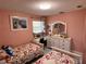 Comfortable bedroom featuring twin beds, a dresser, and a view to the window at 240 Patterson Ave, Osprey, FL 34229