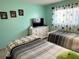 Nicely decorated bedroom features twin beds, and neutral colored walls at 240 Patterson Ave, Osprey, FL 34229