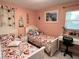 Cozy bedroom featuring twin beds with matching peach-themed bedding and a decorative desk at 240 Patterson Ave, Osprey, FL 34229