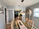 Dining room showcases a glass table, stylish chandelier, and seamless connection to the kitchen and living area at 240 Patterson Ave, Osprey, FL 34229