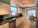 Functional kitchen featuring stainless steel appliances, white cabinets, and an adjacent dining area at 240 Patterson Ave, Osprey, FL 34229