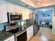 Updated kitchen features stainless steel appliances, ample cabinet space, and stylish countertops at 240 Patterson Ave, Osprey, FL 34229