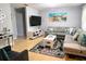 Comfortable living room with a large sectional, modern decor, and light hardwood floors at 240 Patterson Ave, Osprey, FL 34229