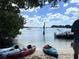 Kayaks lined up on a sandy beach, with boats anchored in the calm blue water at 240 Patterson Ave, Osprey, FL 34229