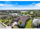 Stunning aerial view of a luxurious home nestled beside a picturesque lake and golf course at 26725 Raphis Royale Blvd, Englewood, FL 34223