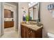 Charming bathroom featuring a granite countertop, wood cabinets, and nautical decor at 26725 Raphis Royale Blvd, Englewood, FL 34223