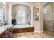This beautiful bathroom features a soaking tub, walk-in shower, and granite countertops at 26725 Raphis Royale Blvd, Englewood, FL 34223