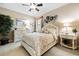 This bedroom features a comfy queen-size bed, a ceiling fan, and a dresser at 26725 Raphis Royale Blvd, Englewood, FL 34223