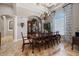 Formal dining room with a large wooden table, elegant chandelier, and classic decor at 26725 Raphis Royale Blvd, Englewood, FL 34223