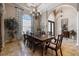 Elegant dining room featuring a large table and chairs beneath a decorative chandelier fixture at 26725 Raphis Royale Blvd, Englewood, FL 34223