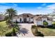 Charming single-Gathering home featuring a well-manicured lawn, brick driveway, and beautiful landscaping at 26725 Raphis Royale Blvd, Englewood, FL 34223