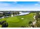 Scenic aerial view of the golf course and waterfront homes in a beautiful community at 26725 Raphis Royale Blvd, Englewood, FL 34223