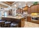 Spacious gourmet kitchen with a large island, stainless steel appliances, and custom cabinets at 26725 Raphis Royale Blvd, Englewood, FL 34223