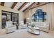 Bright living room features vaulted ceilings, statement window, and comfortable furniture overlooking a screened patio at 26725 Raphis Royale Blvd, Englewood, FL 34223
