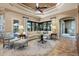 Bright living room with plush seating, decorative lamps, and windows providing natural light at 26725 Raphis Royale Blvd, Englewood, FL 34223