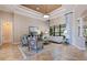 Sophisticated living room with tray ceiling, custom drapes, and stylish seating arrangement at 26725 Raphis Royale Blvd, Englewood, FL 34223