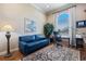 Bright office features hardwood floors, blue sofa, and a large window at 26725 Raphis Royale Blvd, Englewood, FL 34223