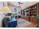 Inviting home office with custom built-in bookshelves, desk area, and comfortable seating at 26725 Raphis Royale Blvd, Englewood, FL 34223