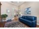 Serene office features hardwood floors, blue sofa, and french doors to another room at 26725 Raphis Royale Blvd, Englewood, FL 34223