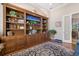 Charming office with hardwood floors features custom built-in bookshelves at 26725 Raphis Royale Blvd, Englewood, FL 34223
