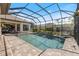 This screened-in pool and spa have a brick deck with great views of the house and landscaping at 26725 Raphis Royale Blvd, Englewood, FL 34223