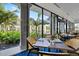 A restaurant table with views of landscaped scenery and palm trees through large windows at 26725 Raphis Royale Blvd, Englewood, FL 34223