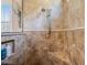 This tiled walk-in shower features a shower head, shower wand, and a built-in bench at 26725 Raphis Royale Blvd, Englewood, FL 34223