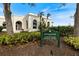 Tennis and fitness center sign surrounded by lush landscaping at 26725 Raphis Royale Blvd, Englewood, FL 34223