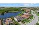 Aerial view of upscale homes situated on a lake with mature trees at 2818 Starwood Ct, Lakewood Ranch, FL 34211