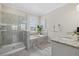 Bright bathroom featuring a walk-in shower, soaking tub, and granite countertops at 2818 Starwood Ct, Lakewood Ranch, FL 34211