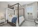 Bright bedroom with a four poster bed, chandelier, wood floors and view to the outside at 2818 Starwood Ct, Lakewood Ranch, FL 34211