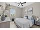 Cozy bedroom featuring a light-colored bed, dresser, and shuttered window at 2818 Starwood Ct, Lakewood Ranch, FL 34211