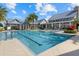 Inviting community pool featuring multiple lanes, lush landscaping, and a well-maintained pool house at 2818 Starwood Ct, Lakewood Ranch, FL 34211