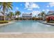 Spacious community pool with a zero depth entry surrounded by lush landscaping and comfortable seating areas at 2818 Starwood Ct, Lakewood Ranch, FL 34211