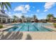 Resort-style pool with lane markers, palm trees, and spacious deck area in a beautiful community setting at 2818 Starwood Ct, Lakewood Ranch, FL 34211