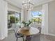 Cozy dining area boasts a round table, view to the backyard pool and ample natural light at 2818 Starwood Ct, Lakewood Ranch, FL 34211