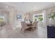 Bright dining room boasts modern chandelier, neutral tones, and a large window letting in natural light at 2818 Starwood Ct, Lakewood Ranch, FL 34211